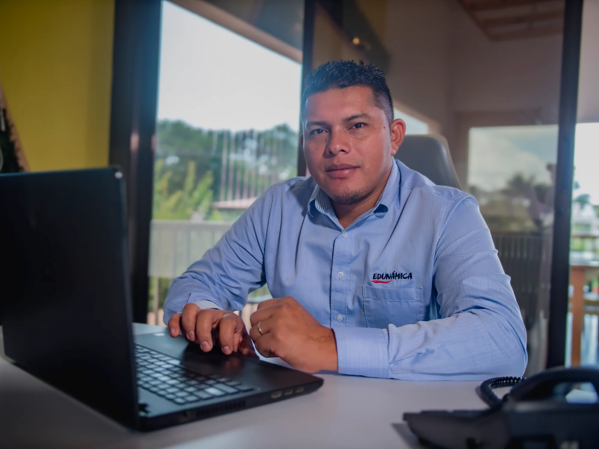 Institutional portrait of an Edunámica staff member working on his laptop